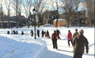 wide shot of skaters back on enjoying the Loop with houses in the distance