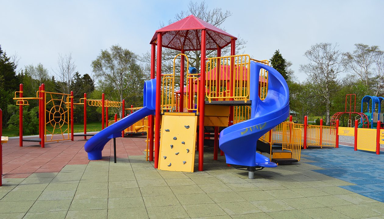 Colourful pieces of metal and plastic playground equipment at Bowring Park