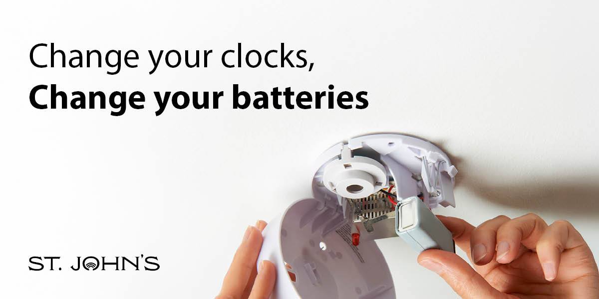 white background with someone changing the batteries in a smoke detector with black text 