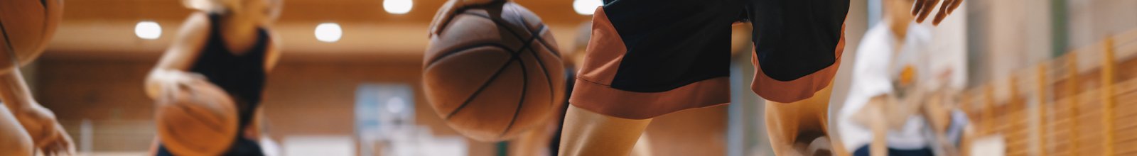 Group of people dribbling basketballs