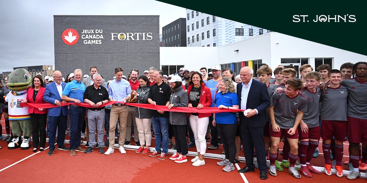 Partners and guests gather to cut the ribbon at the Grand Opening of the Fortis Canada Games Complex.