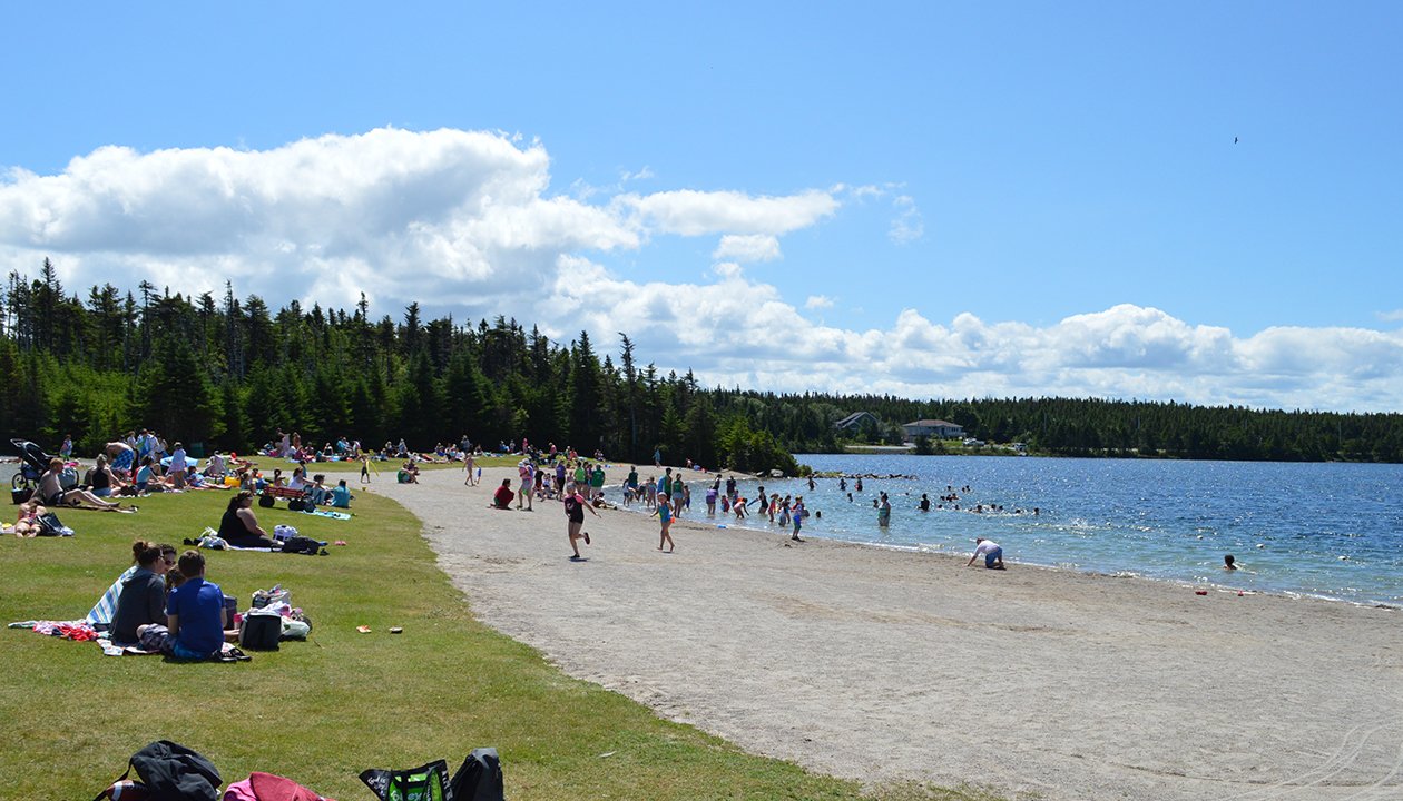 People enjoying Rotary Park beach on Healey's Pond