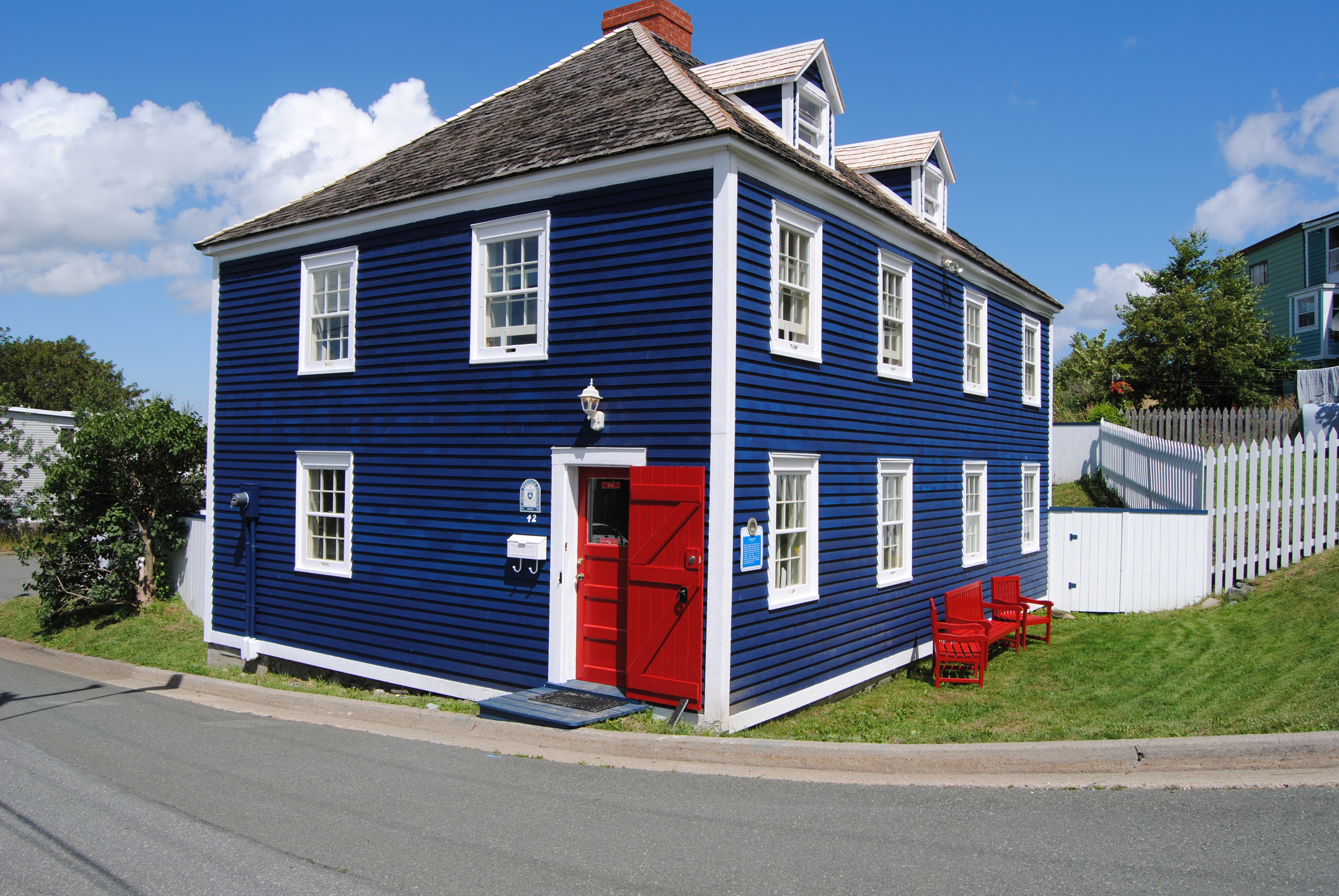 A Heritage home in St. John's. A simple two-storey house with blue clapboard siding. The home is located on Signal Hill.