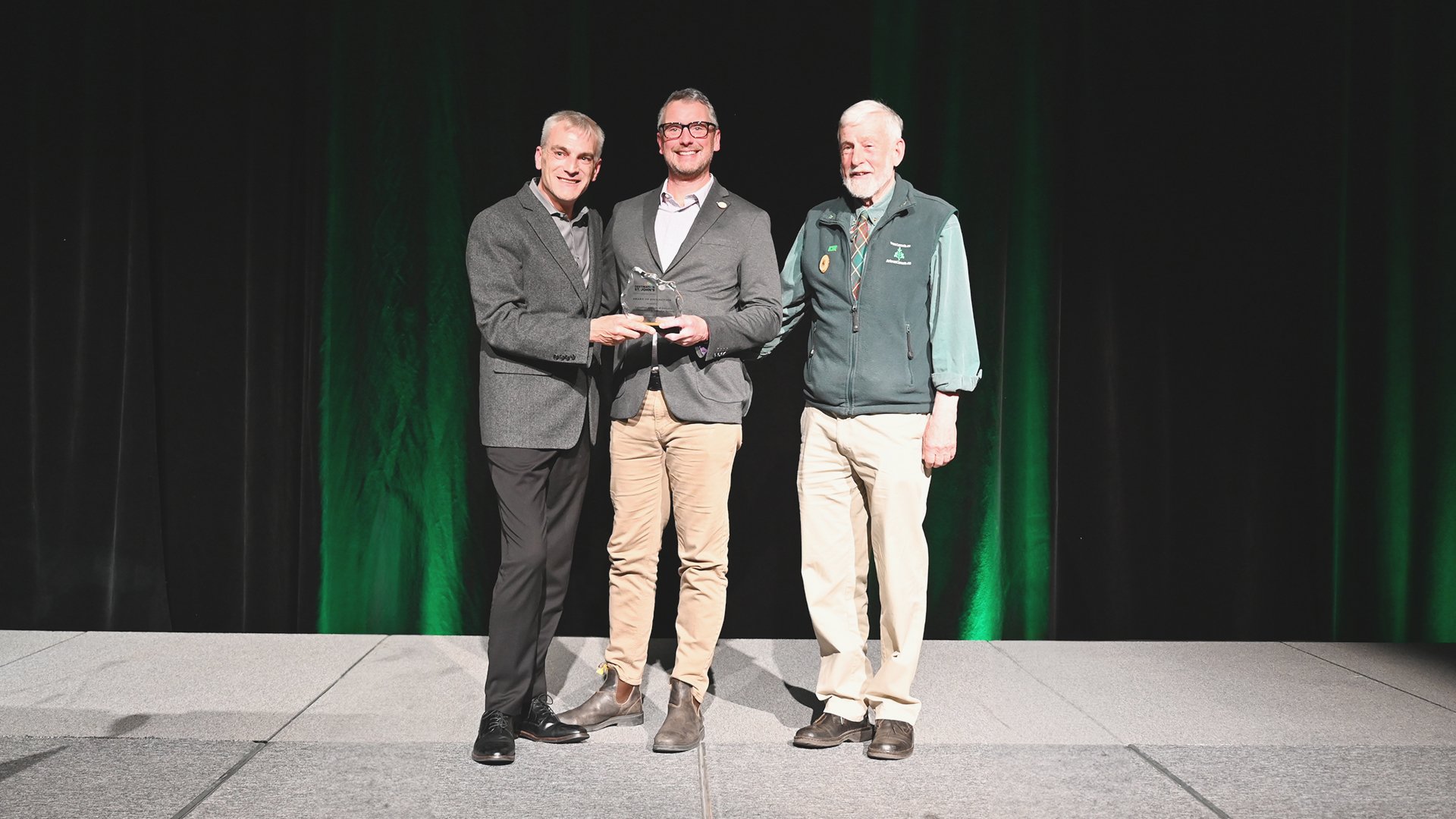 Destination St. John's CEO Paul Bugge, left presents Sean Greene and Bruce Roberts, right, with the Destination St. John's Award of Distinction.