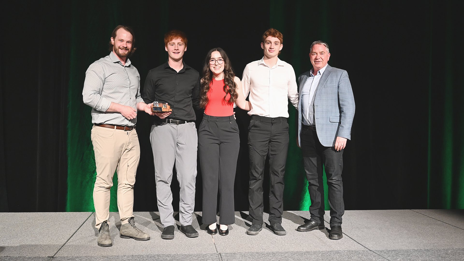 Councillor Greg Noseworthy, left, presents representatives of Waterford Valley High Community Outreach Network with the Group Volunteer of the Year Award.