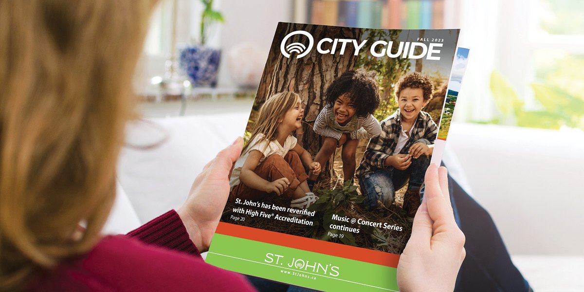 Person reading the Fall 2023 City Guide