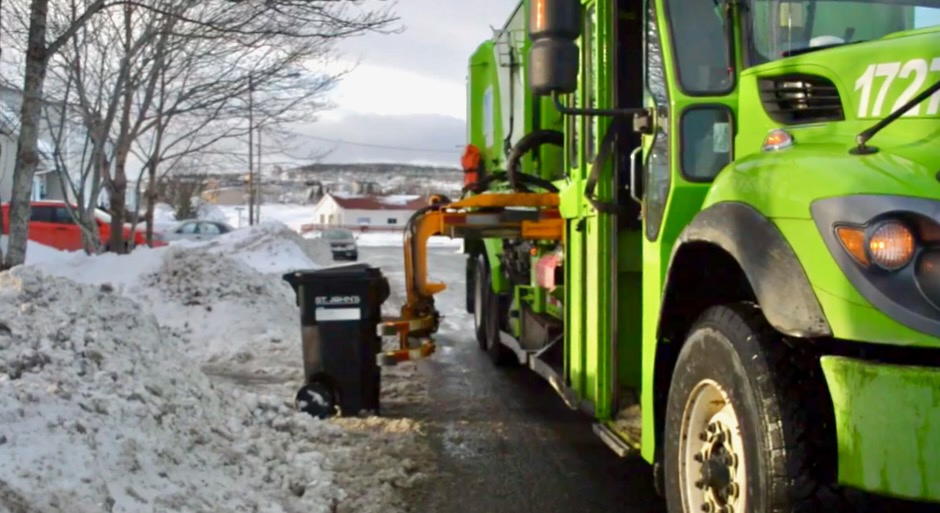 Image of cart placed properly at the curb and a garbage truck picking it up