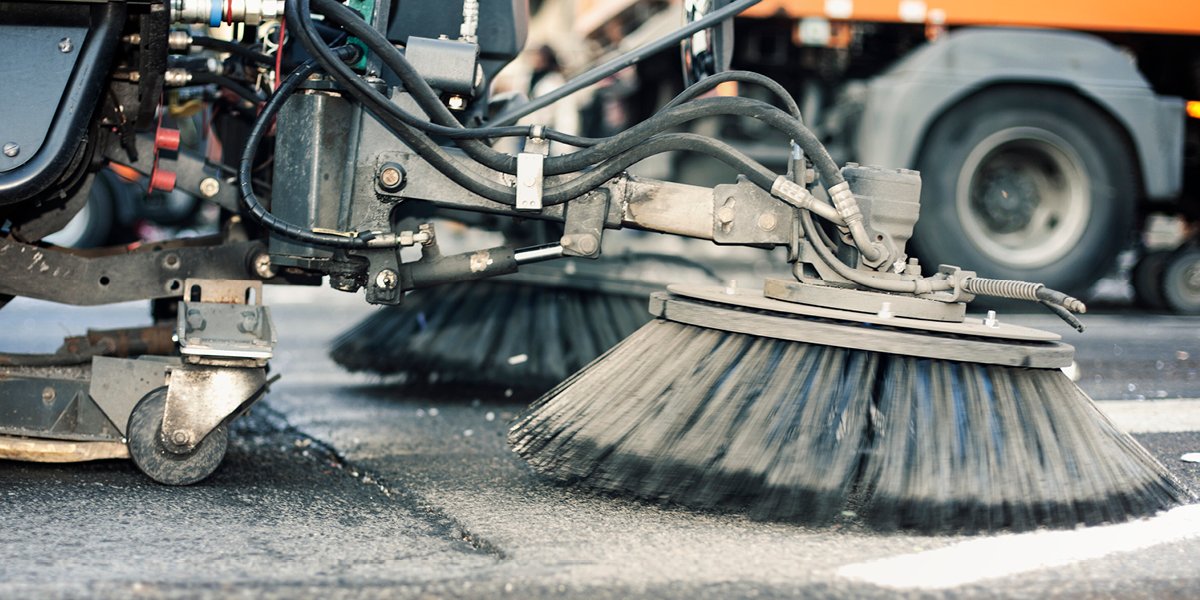 Image of street cleaning equipment cleaning the street