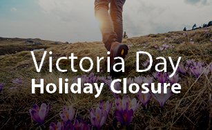 Background of field with purple flowers and text "Victoria Day Holiday Closure"