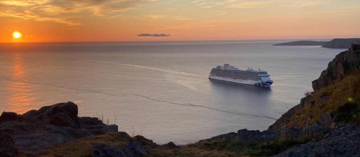 sun setting over the Narrows as a cruise ship sails out to sea