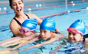 a swim instructor teaching children swimming lessons. 