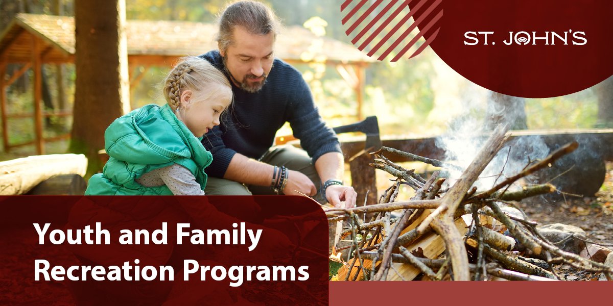 a parent and child building a fire together. 
