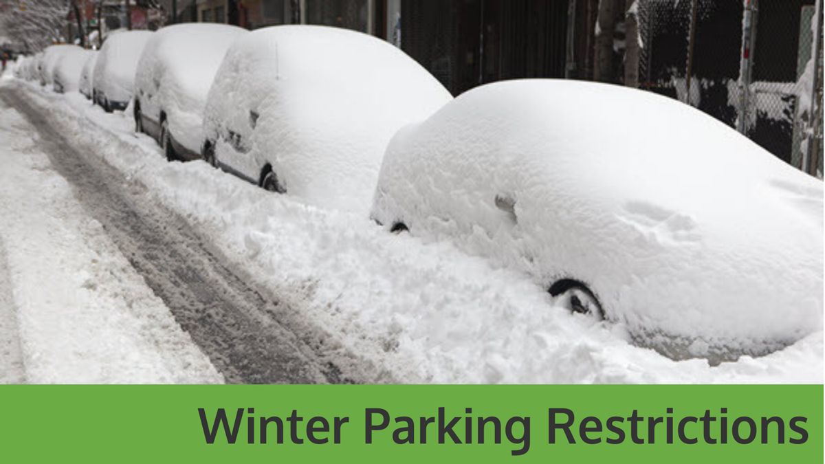 Snow on cars with the words "Winter Parking Restrictions"