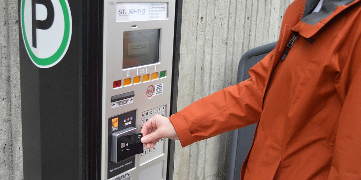 A patron using a parking pay station