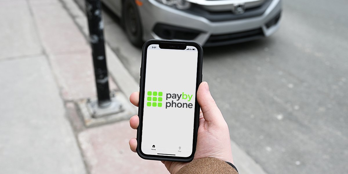 Image of a person using the PayByPhone app on a smart phone