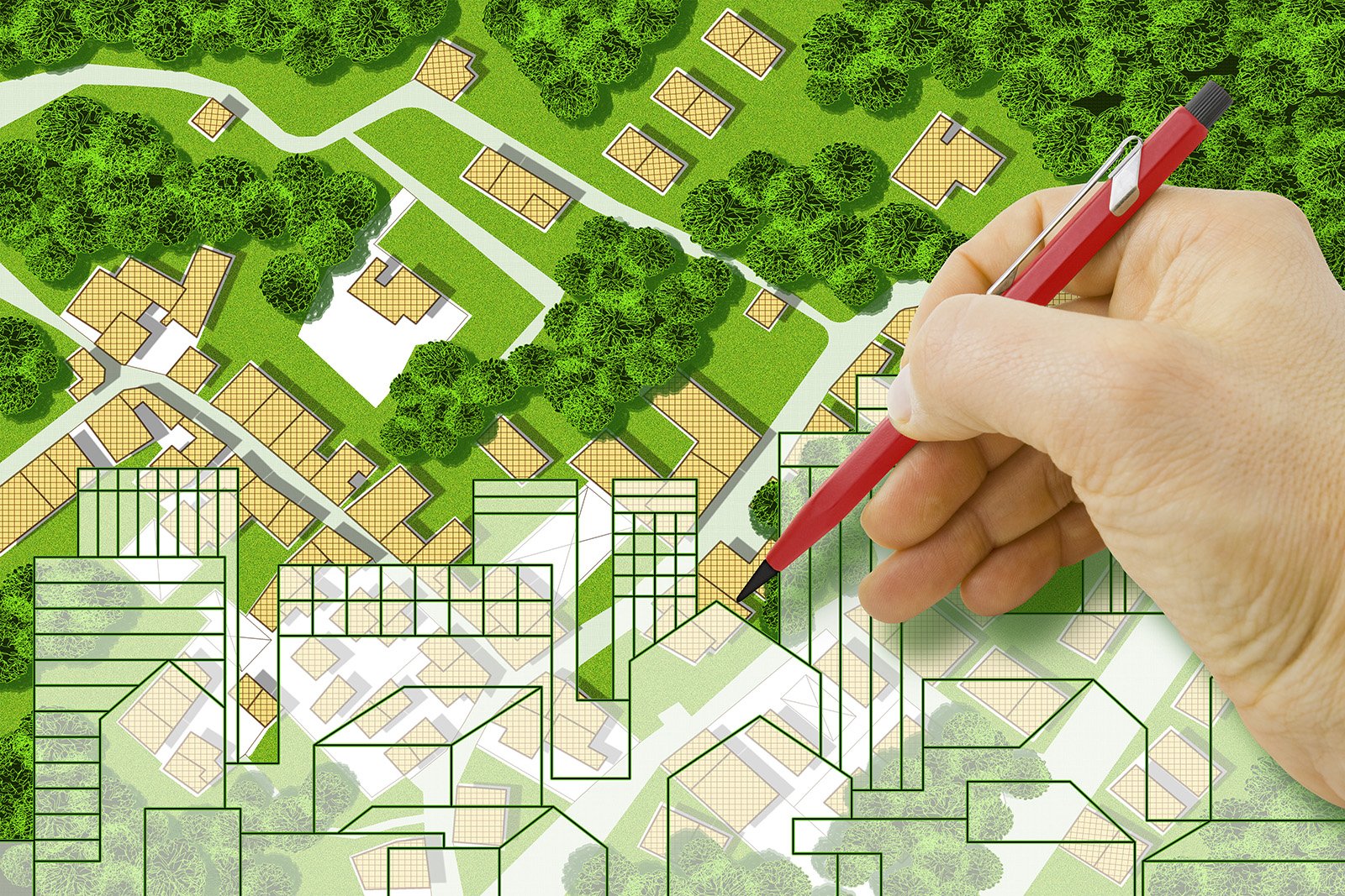 illustration of aerial street map with hand holding pencil drawing buildings in lower half