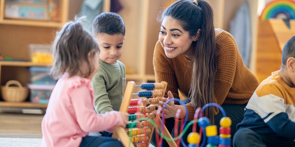 person smiling and playing with children. 