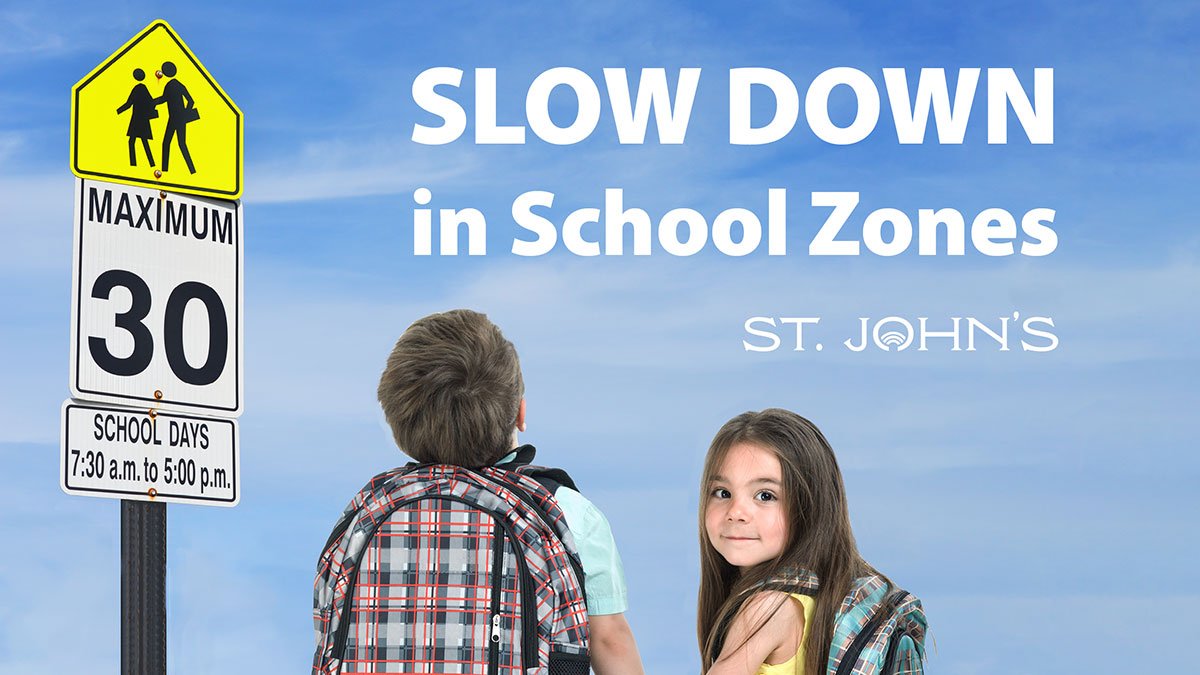 school zone sign and two small children, one smiling at camera, and text: Slow down in School zones