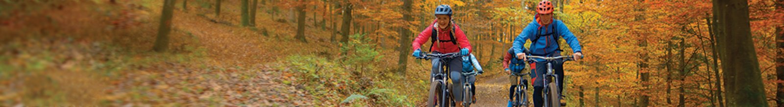 Family of three riding along a path