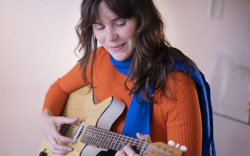 Photo of Nico Paulo playing her guitar