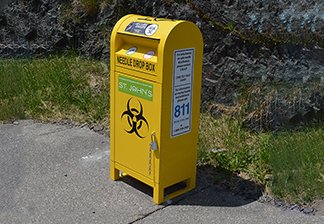 Yellow metal needle disposal box much like a metal mail box