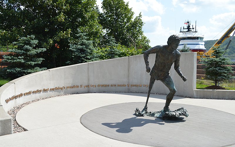 The Terry Fox sculpture located on northwest shore of St. John's Harbour, near the Port St. John's building. The sculpture depicts Terry Fox running with a semi circular wall in background with a quote from Terry Fox.