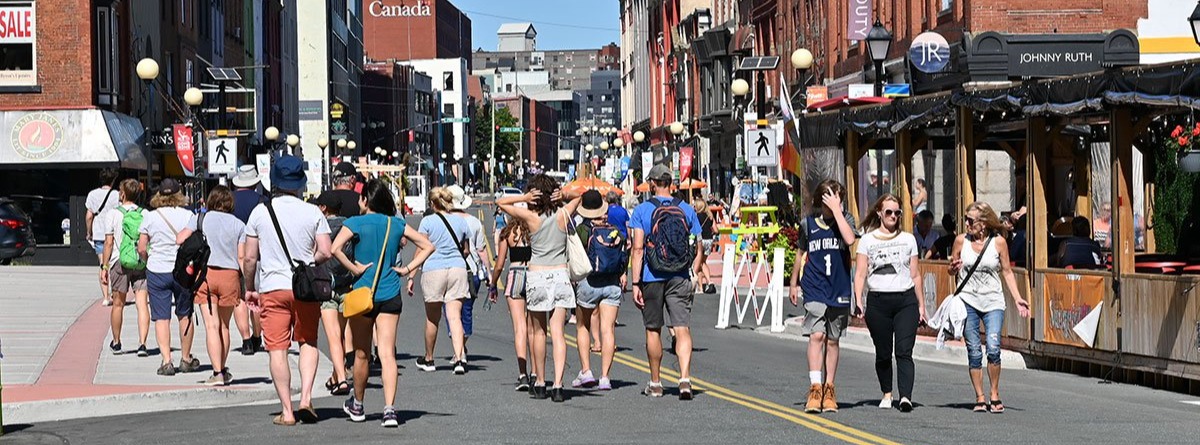 crowds walking down Water Street on a sunny day