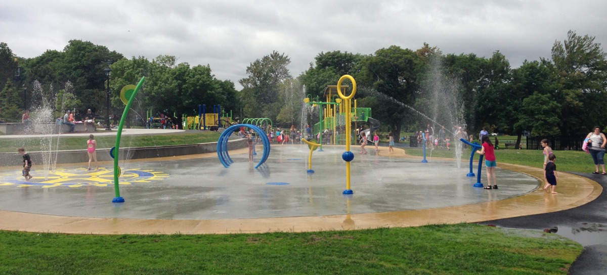 wide shot showing children running through spouting devices at Bannerman Splash Pad