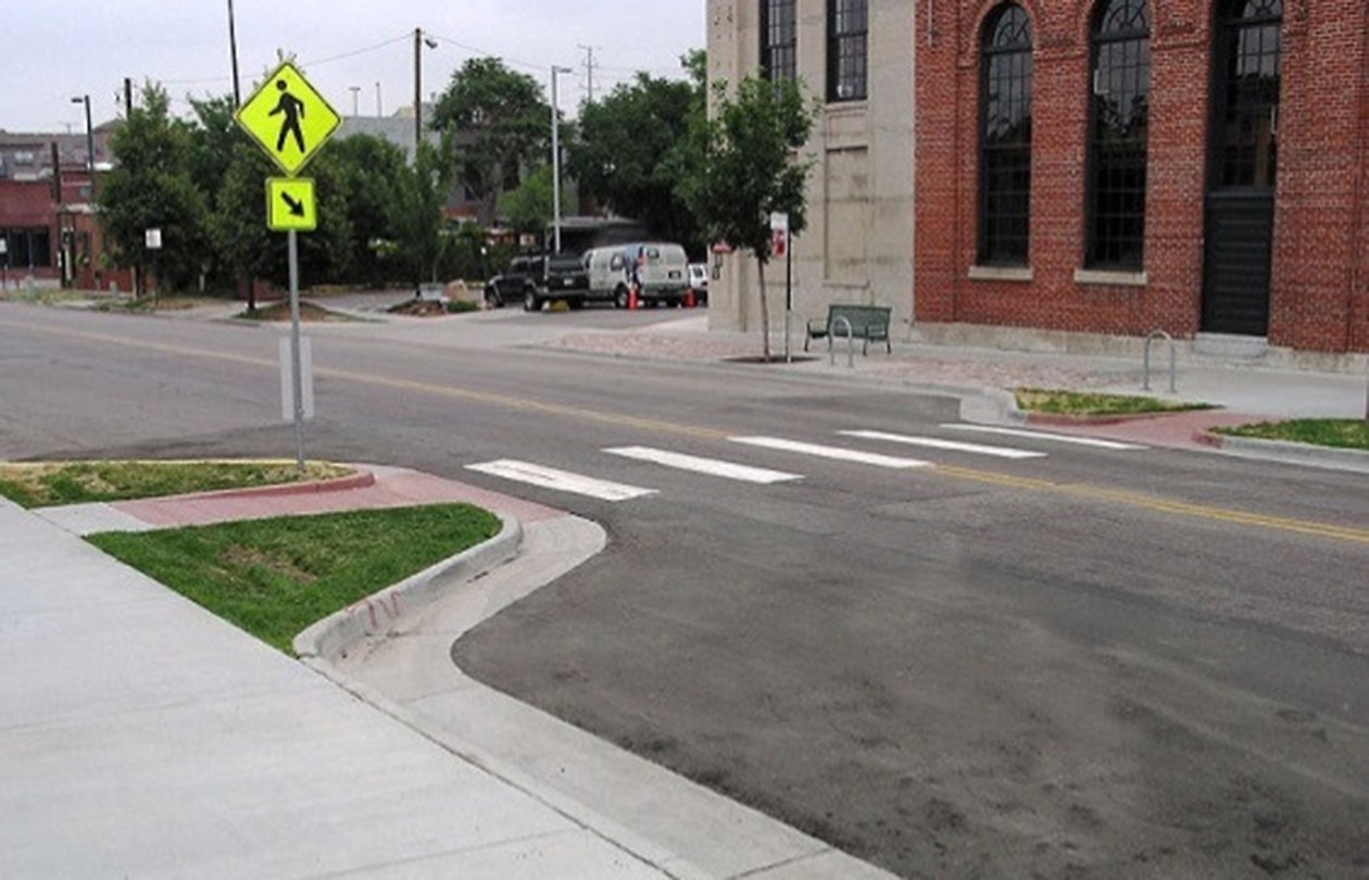 An image of extended curb on a street