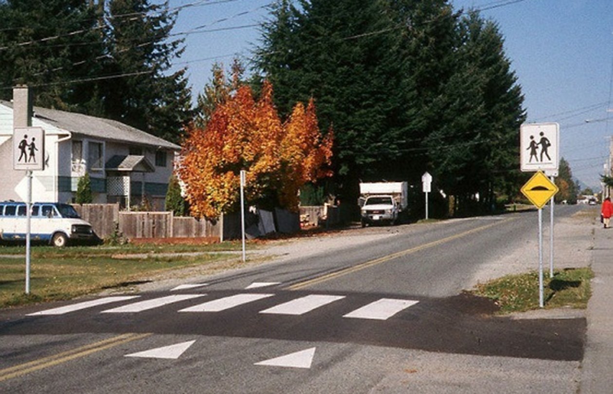 Image of a crosswalk that has been raised with hump of asphalt across a street