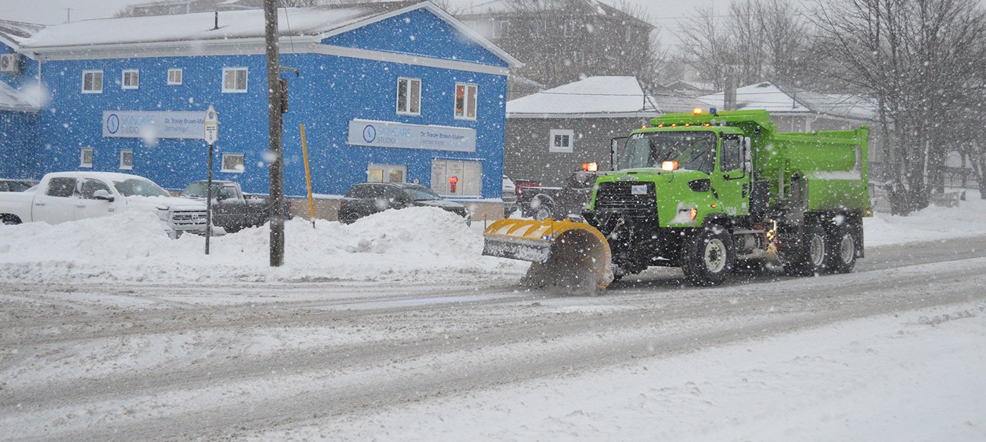 City of St. John's Dump Truck fitted with a snow plow, plowing the streets during a snowy day