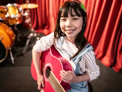 a child playing guitar 