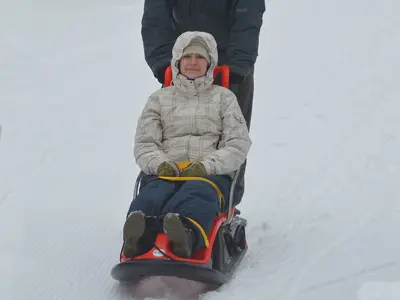 a person in a snowy setting on a snow coach