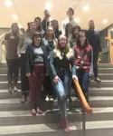 A group of people standing on stairs at City Hall