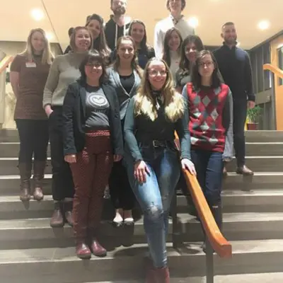 A group of people standing on stairs at City Hall