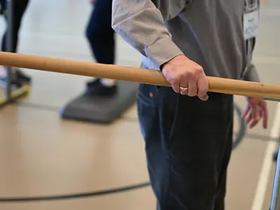 a person using a support bar in a recreation program
