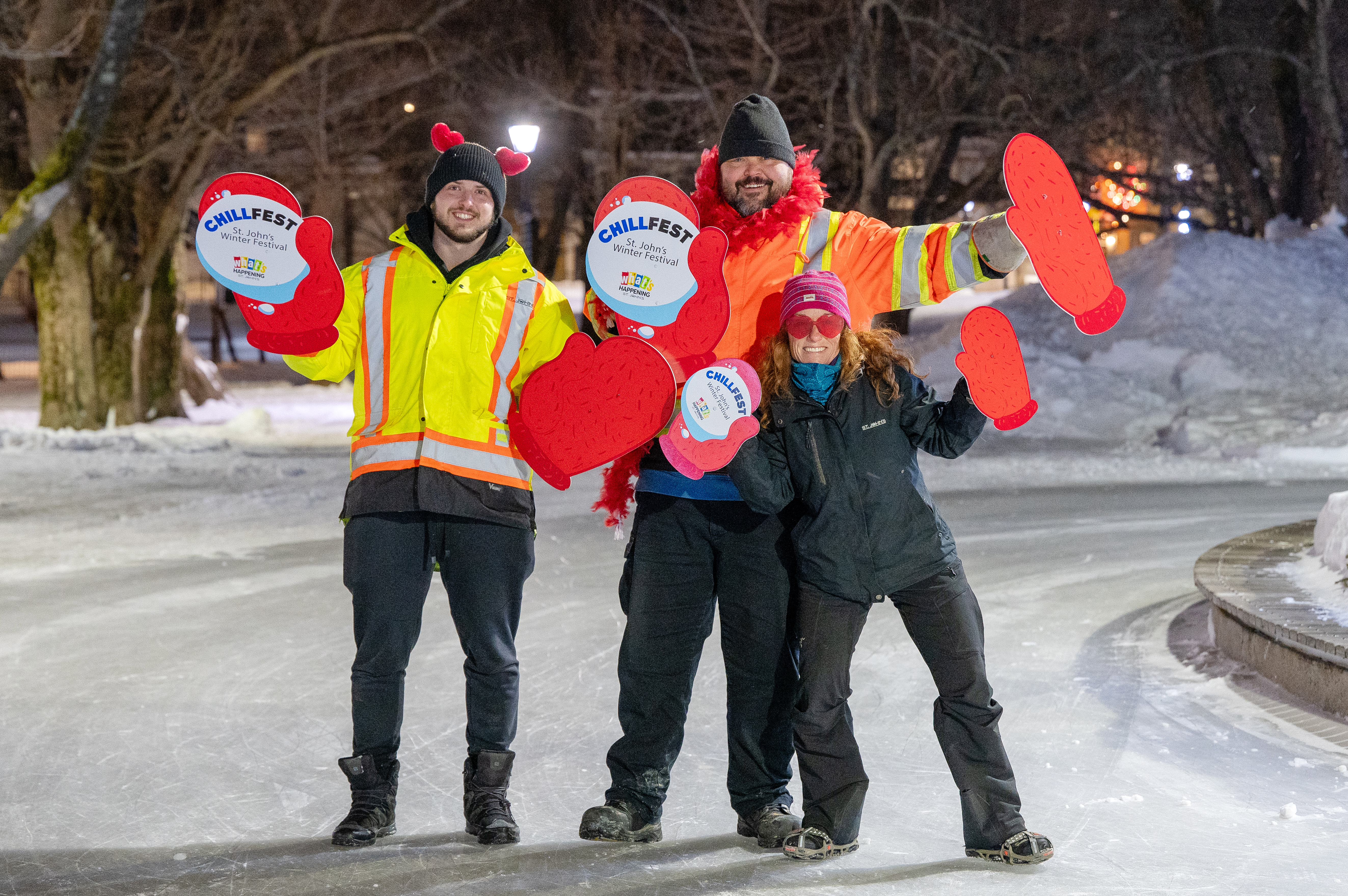 Photo of City Staff at ChillFest Valentine's Skate holding ChillFest Mittens.