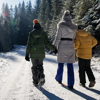 people walking on a trail in the winter