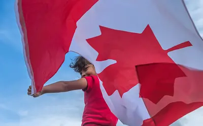 a person holding a Canadian Flag 