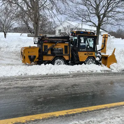 sidewalk snow clearing equipment working on a winter day 
