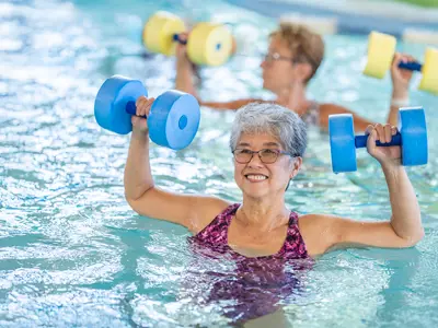 women using water weights in a pool