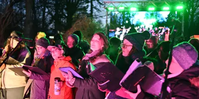 people singing at Holiday Lights