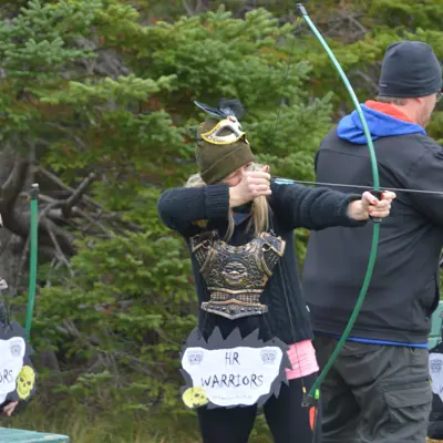 a person doing archery at the park