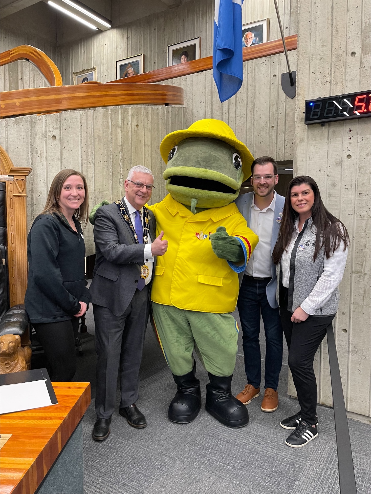 Mayor Breen, City staff and a frog mascot